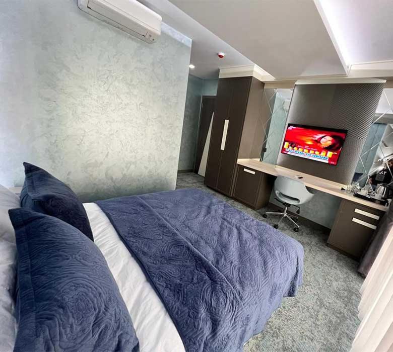 a bedroom with a bed with a tv in it at Forever 21 Hotel in Istanbul