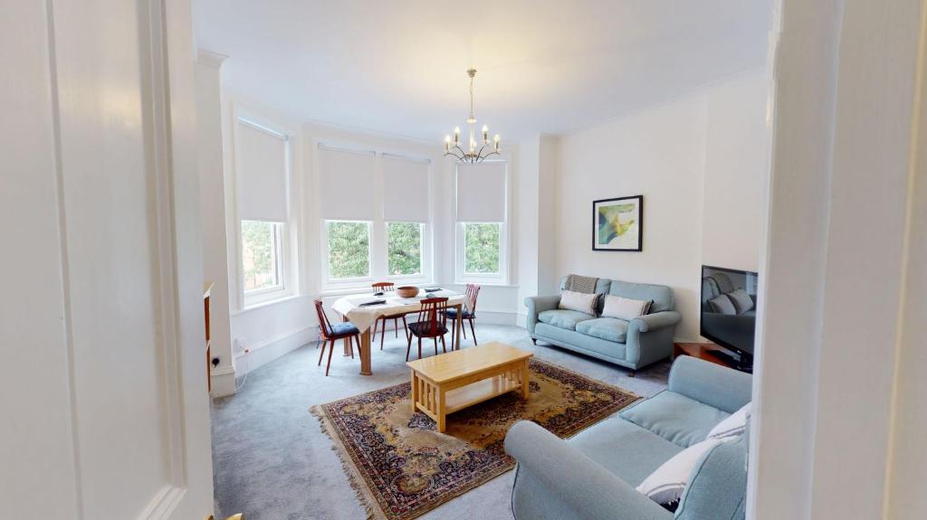 a living room with a blue couch and a table at The Bardwell in Oxford