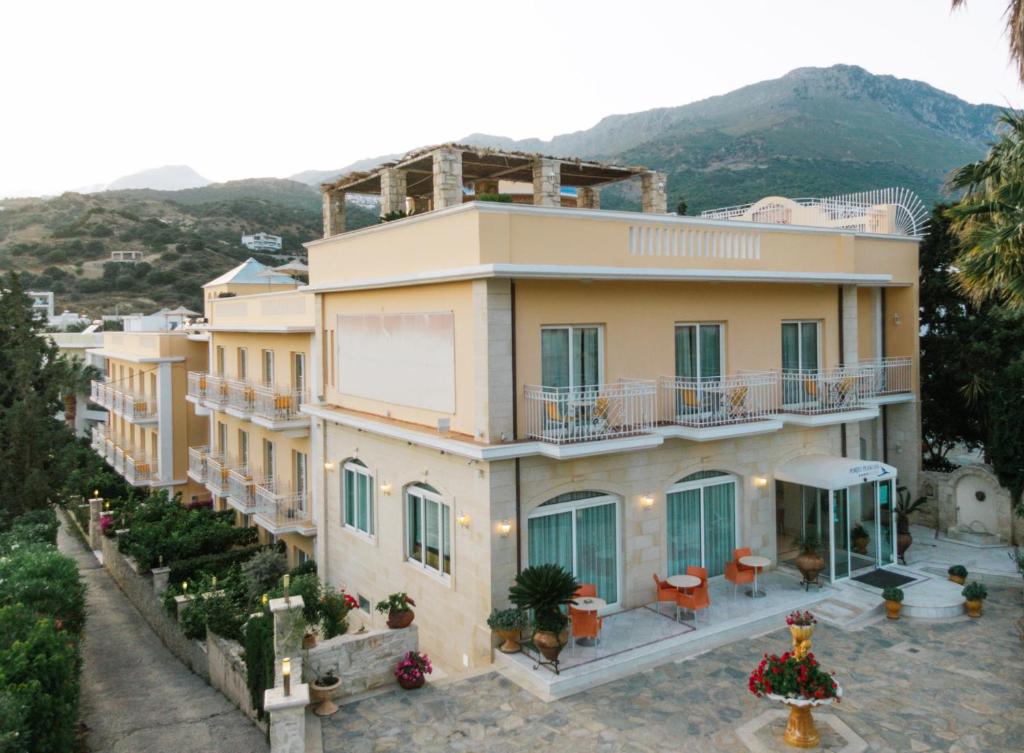an aerial view of a house with a mountain in the background at Porto Plakias & Spa in Plakias