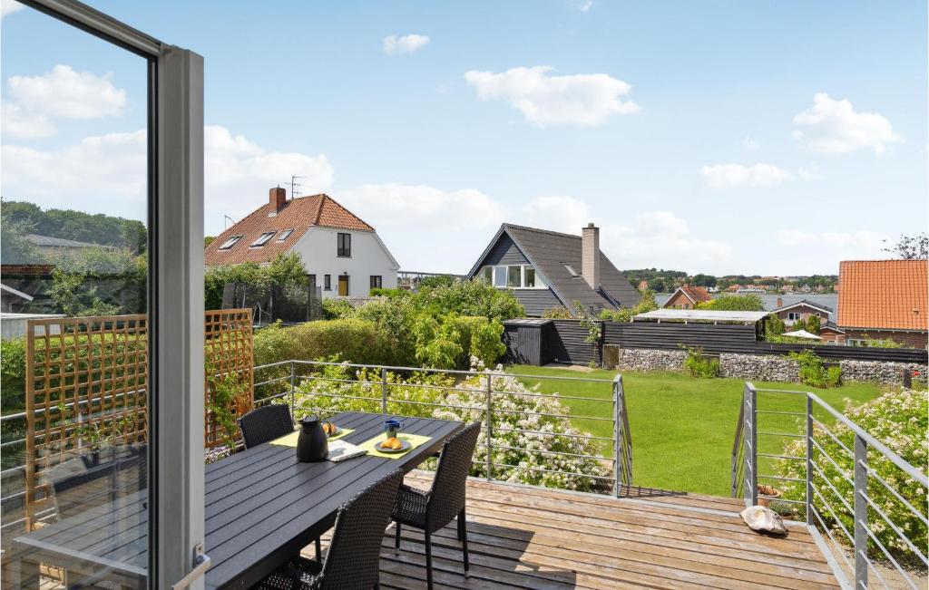 a deck with a table and a view of a yard at Lovely Home In Svendborg With Wifi in Svendborg