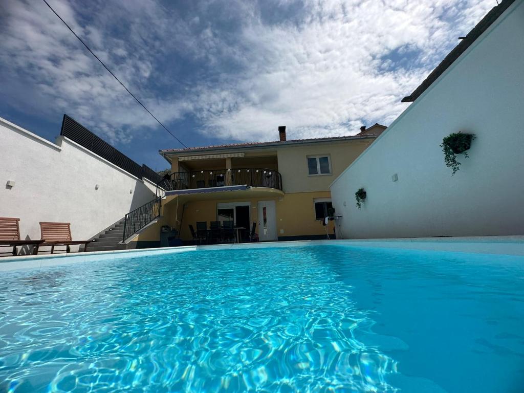 a large swimming pool in front of a house at Villa UpTown in Mostar