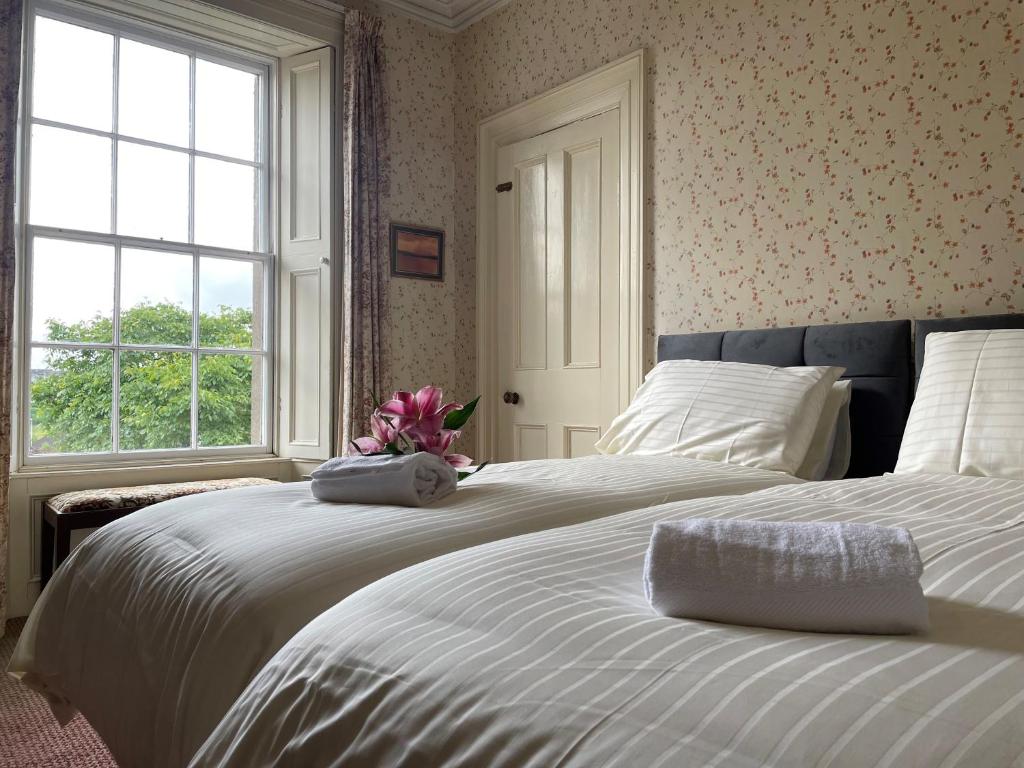 a bedroom with two beds and a window at Willowbank House & Farm in Keady
