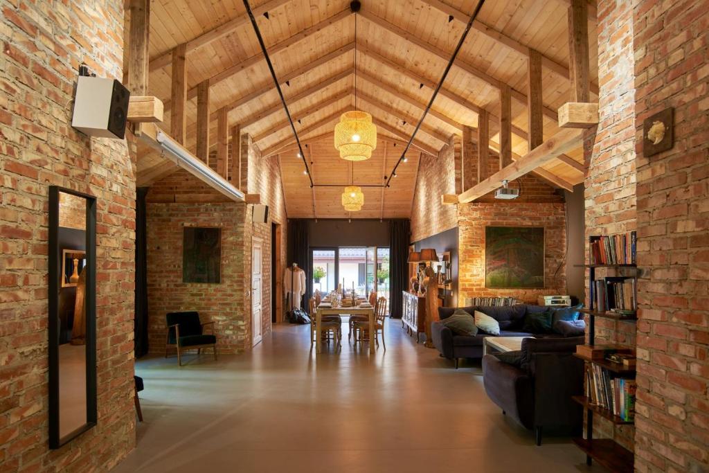a large living room with a brick wall at Villa Kamionka in Kamionka