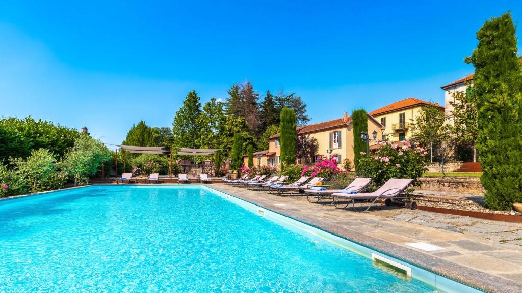 una piscina con tumbonas junto a una casa en Villa La Romantica 14, Emma Villas, en Grognardo