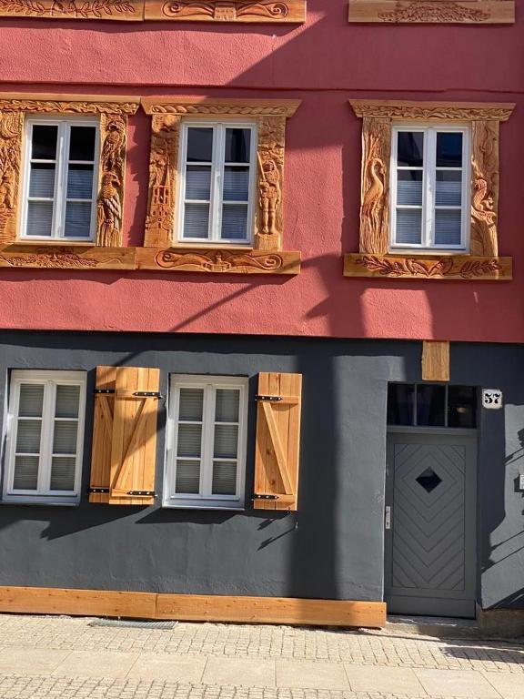 a building with two windows and a door on it at Ferienhaus Harztörchen in Halberstadt