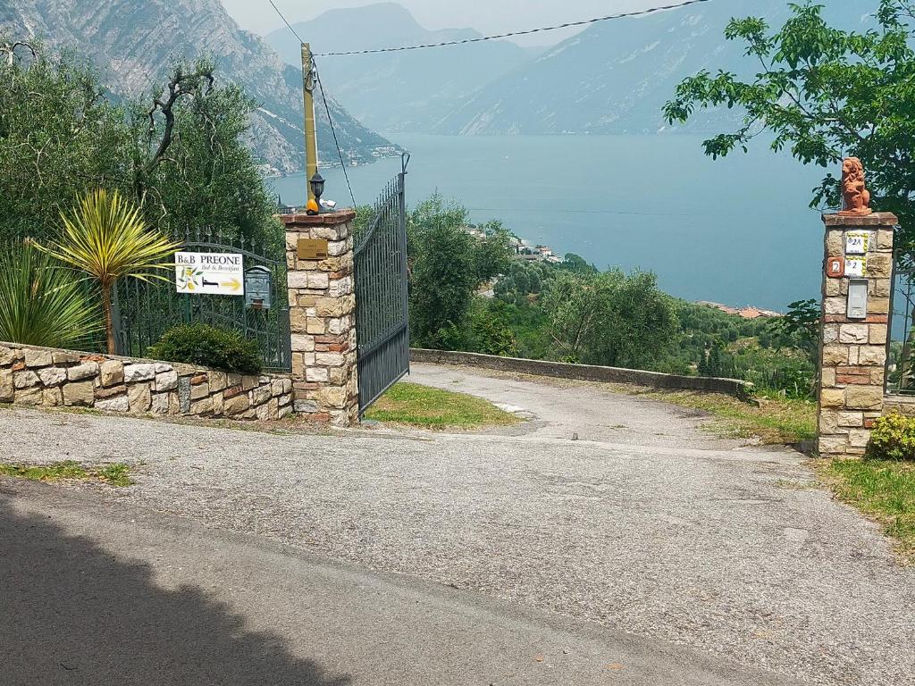 an empty road with a gate and a fence at Appartamento BeB Preone CIR17089BEB01 in Limone sul Garda