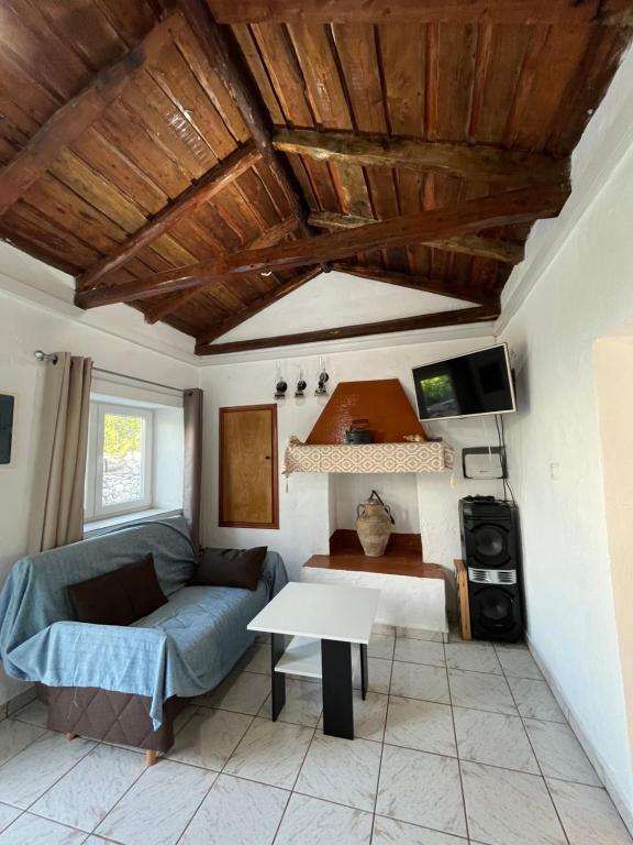a living room with a couch and a table at Rodovani Cottage in Antipaxos