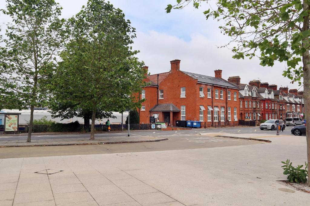 an empty street in a town with brick buildings at Penthouse by the Ipswich Station in Ipswich