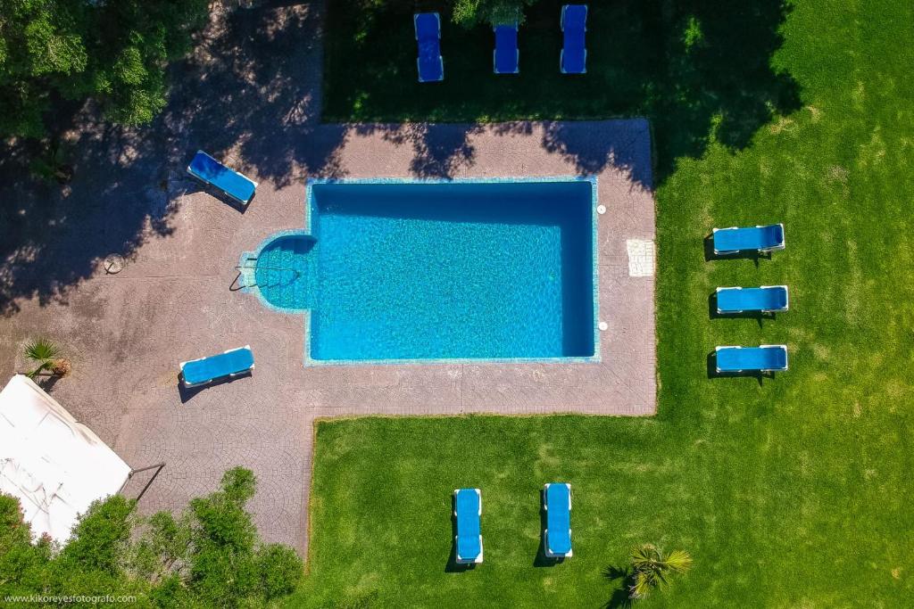 an overhead view of a swimming pool in a yard at Cortijo El Indiviso in Vejer de la Frontera