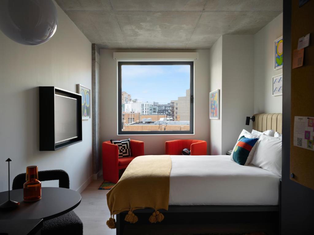 une chambre d'hôtel avec un lit et une fenêtre dans l'établissement Penny Williamsburg, à Brooklyn