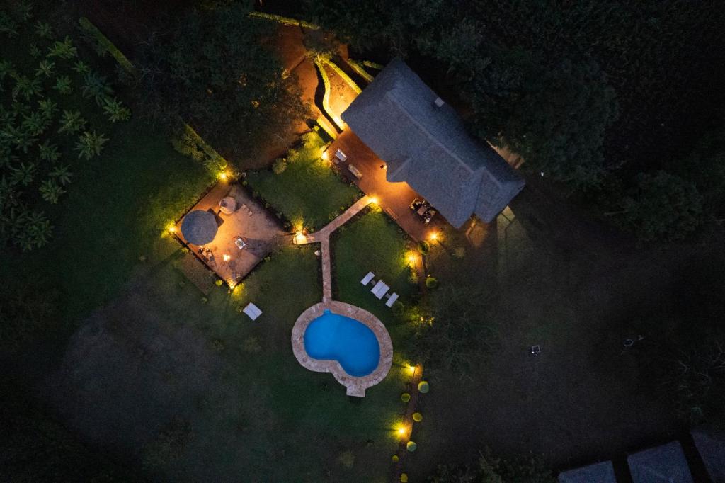 an overhead view of a pool at night with lights at Karatu Tented Lodge in Karatu
