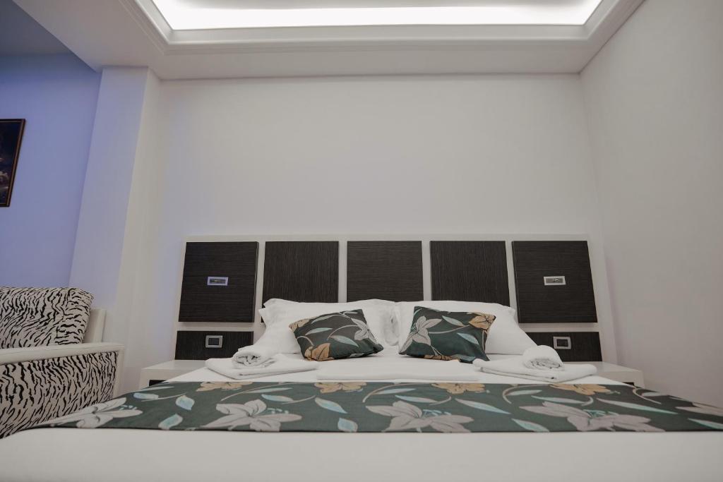 Postel nebo postele na pokoji v ubytování Grand Hotel Aita