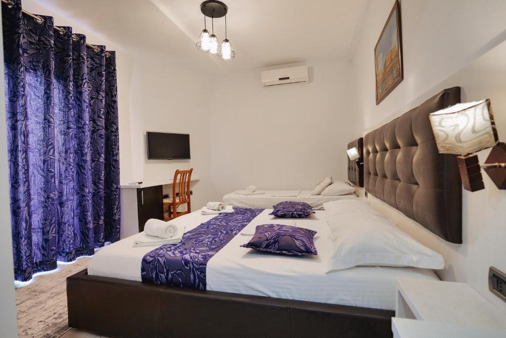 Postel nebo postele na pokoji v ubytování Grand Hotel Aita