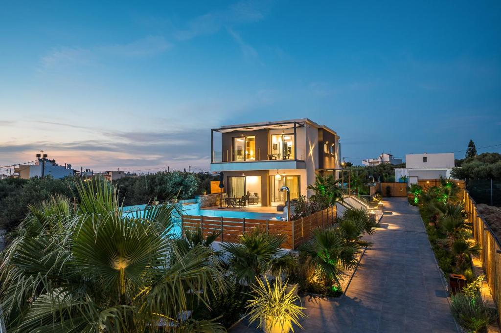 a house with a swimming pool and a villa at Aida Luxury Villas in Hersonissos