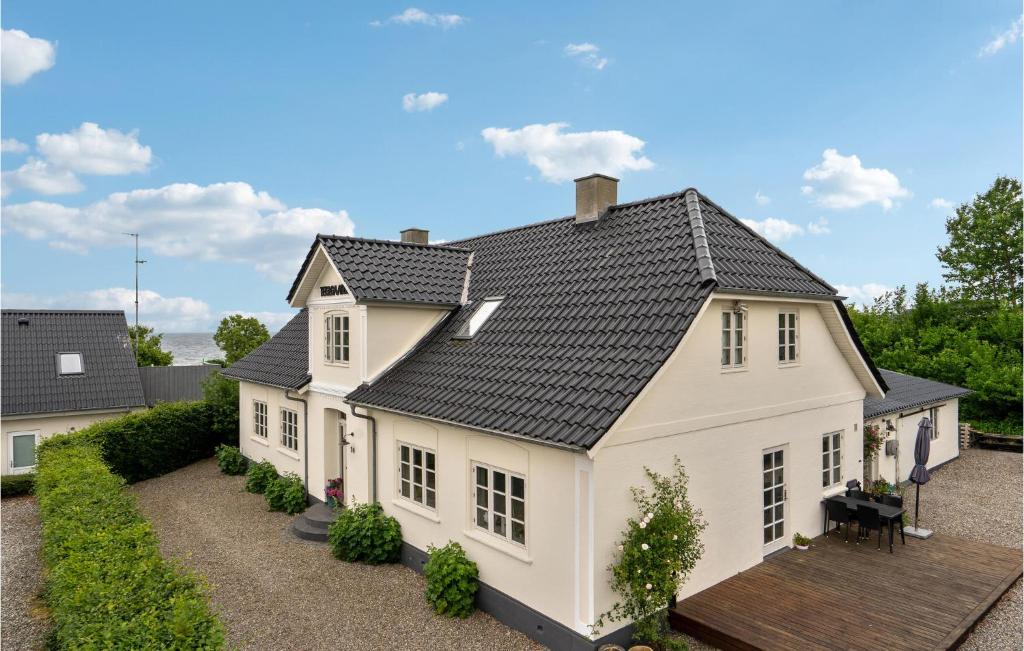 a white house with a black roof at 2 Bedroom Awesome Apartment In Hejls in Hejls