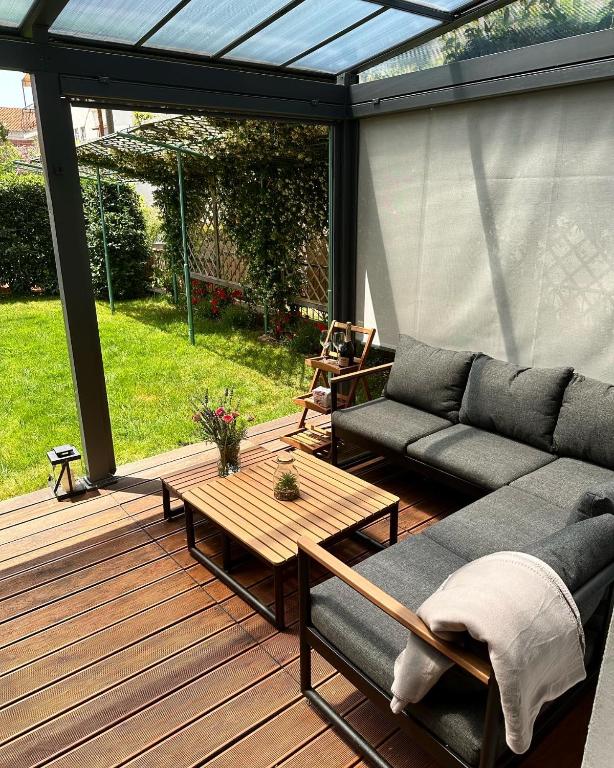 a patio with a couch and a table on a deck at Kuća Aurora in Rovinj