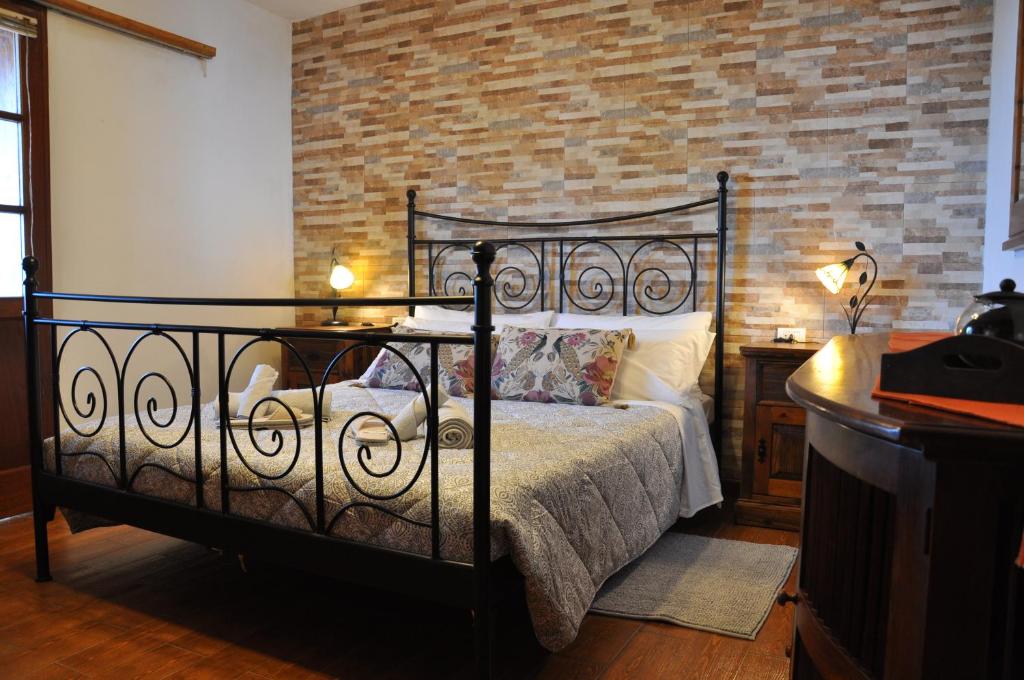 a bedroom with a bed and a brick wall at Oasis Hill Icod de los Vinos in Icod de los Vinos