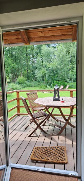 a patio with a table and a chair on a deck at Fewo VOR DEM BERG Bergstraße 21 in Bergstraße