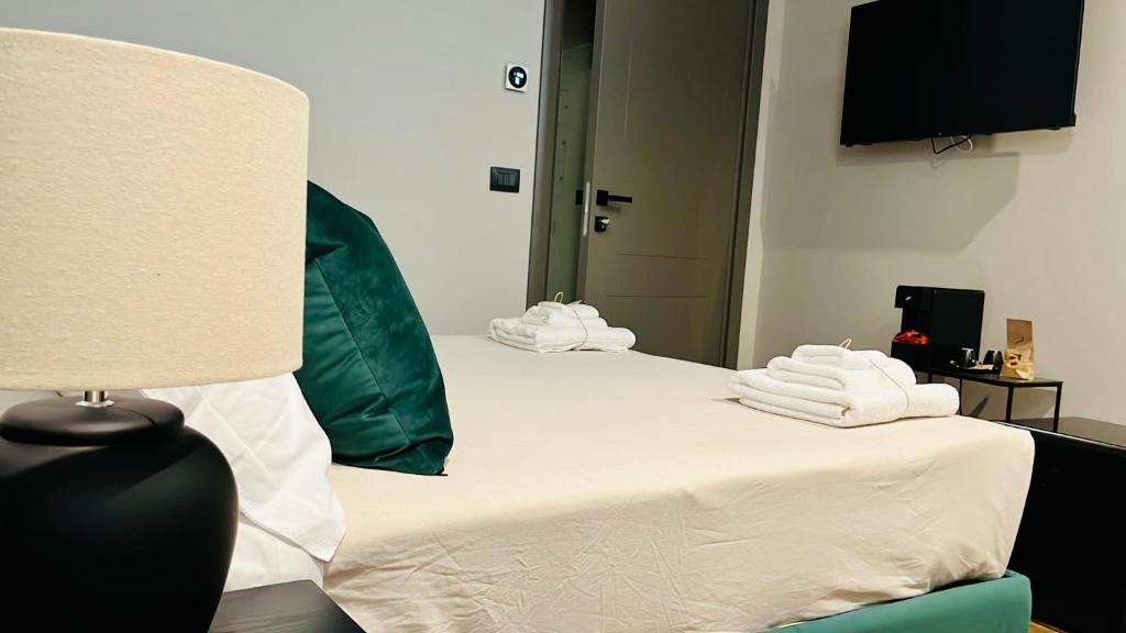 Postel nebo postele na pokoji v ubytování Palazzo Gatto Bianco