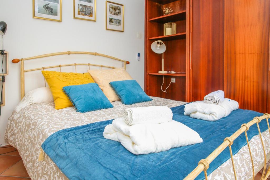 a bedroom with a bed with towels on it at Villa House Joana Vasconcelos, Ocean view & Pool - Pata da Gaivota in Lourinhã