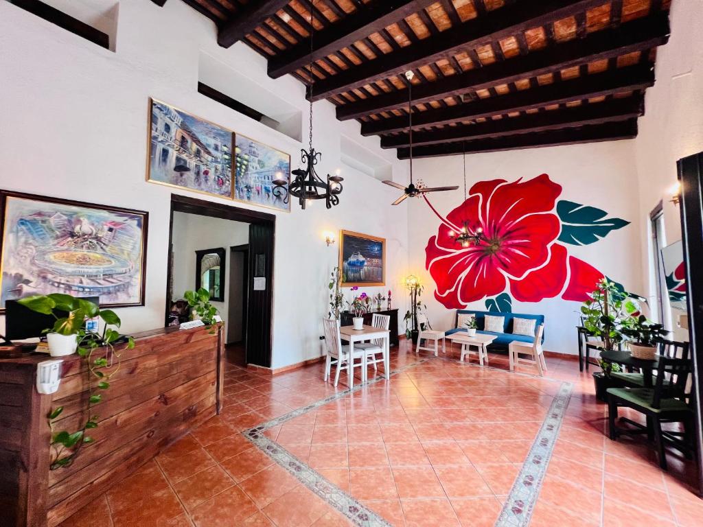 a living room with a large red flower on the wall at Suite Colonial by Cristi in Santo Domingo