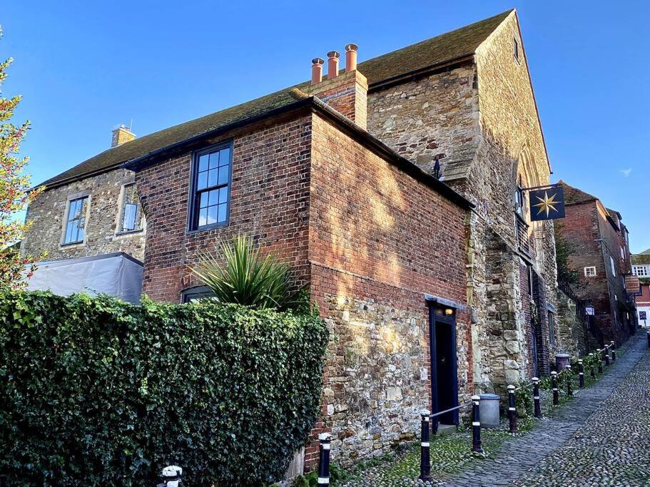 a brick building with a star on the side of it at Monastery Cottage in Rye