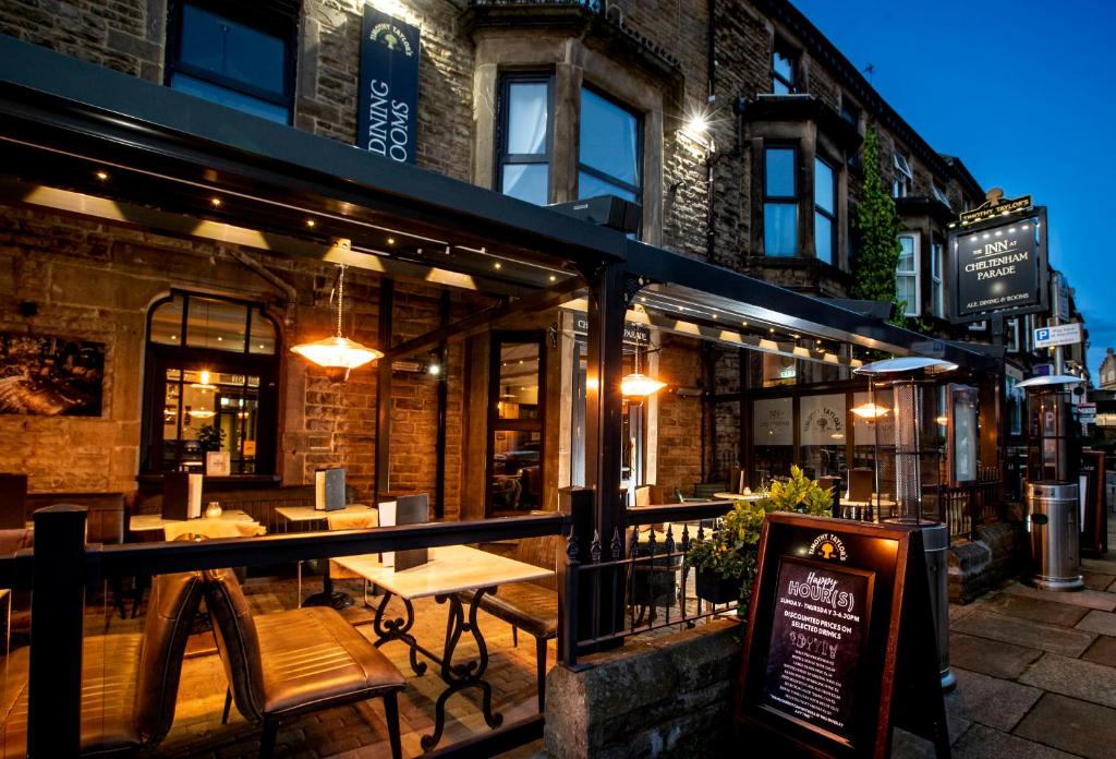 ein Restaurant mit Tischen und Stühlen außerhalb eines Gebäudes in der Unterkunft The Inn at Cheltenham Parade in Harrogate