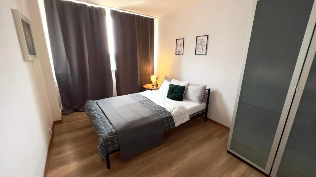 niewielka sypialnia z łóżkiem i oknem w obiekcie Parkcity Chorzów w mieście Chorzów