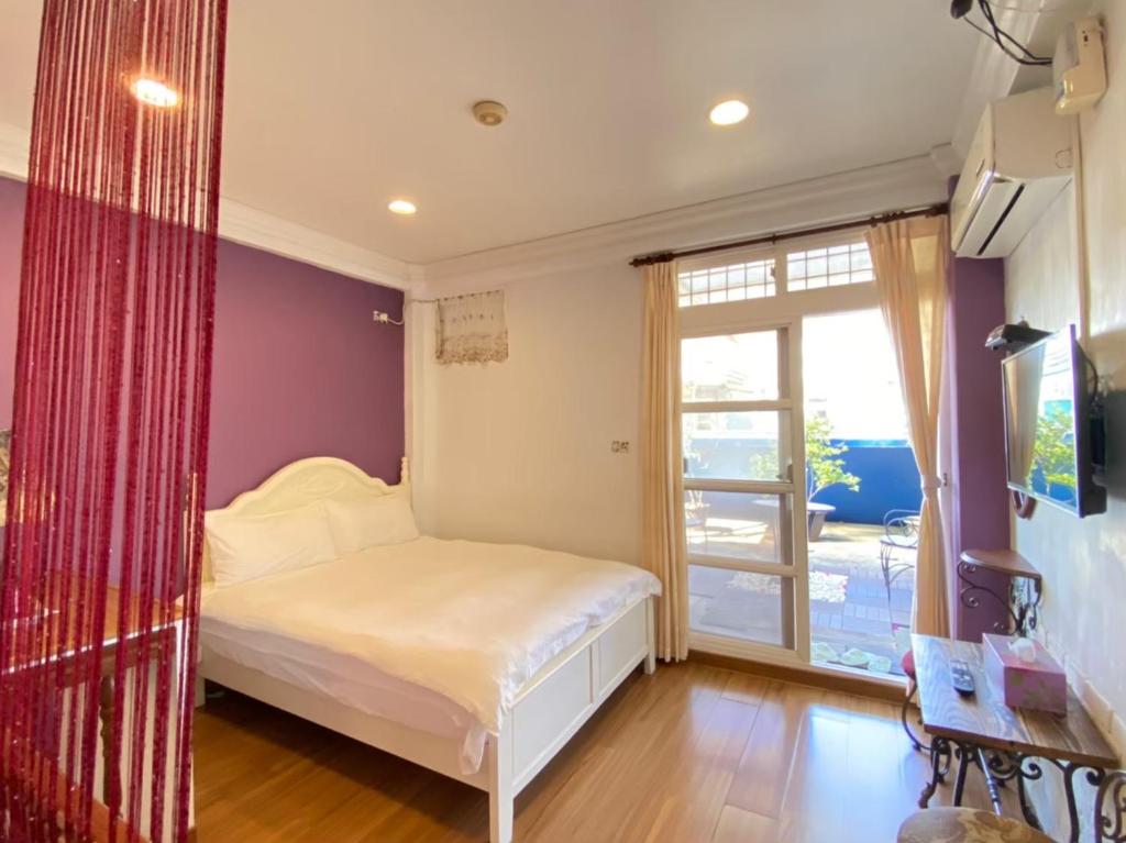 a small bedroom with a bed and a window at Dot Minsu in Wujie