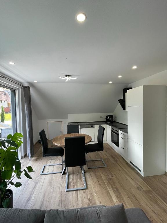 a kitchen with a table and chairs in a room at Gästehaus Miri in Lindau