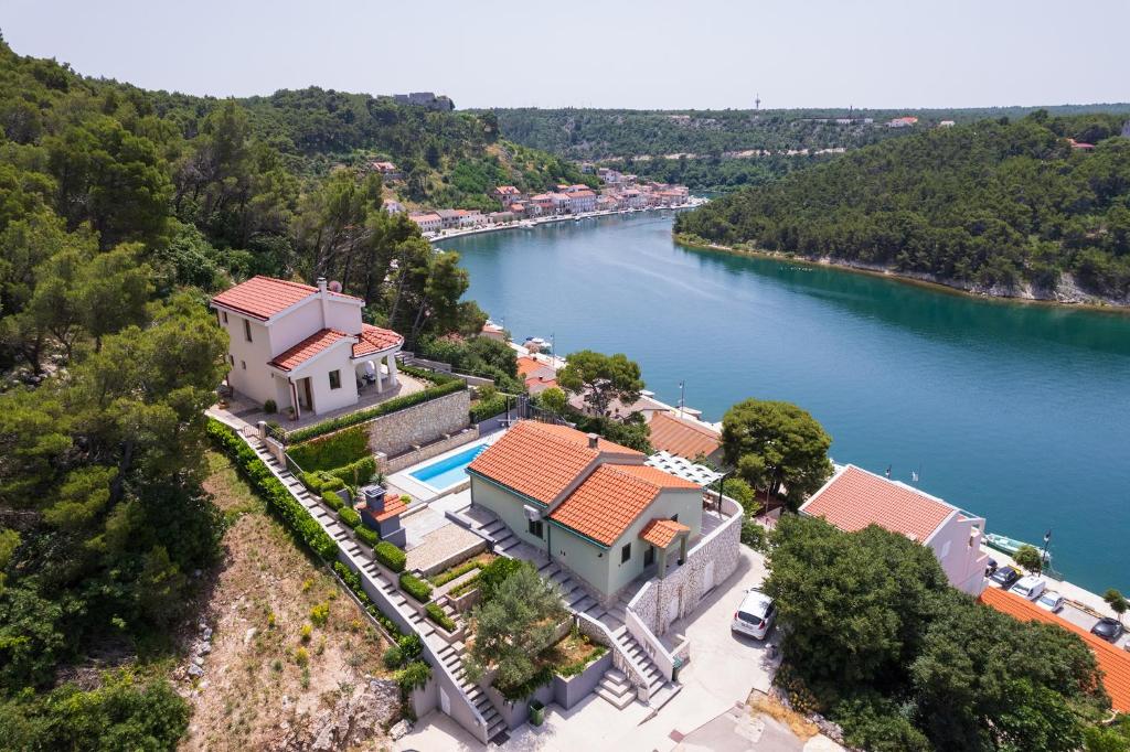 an aerial view of a house on a hill next to a river at Green House in Novigrad Dalmatia