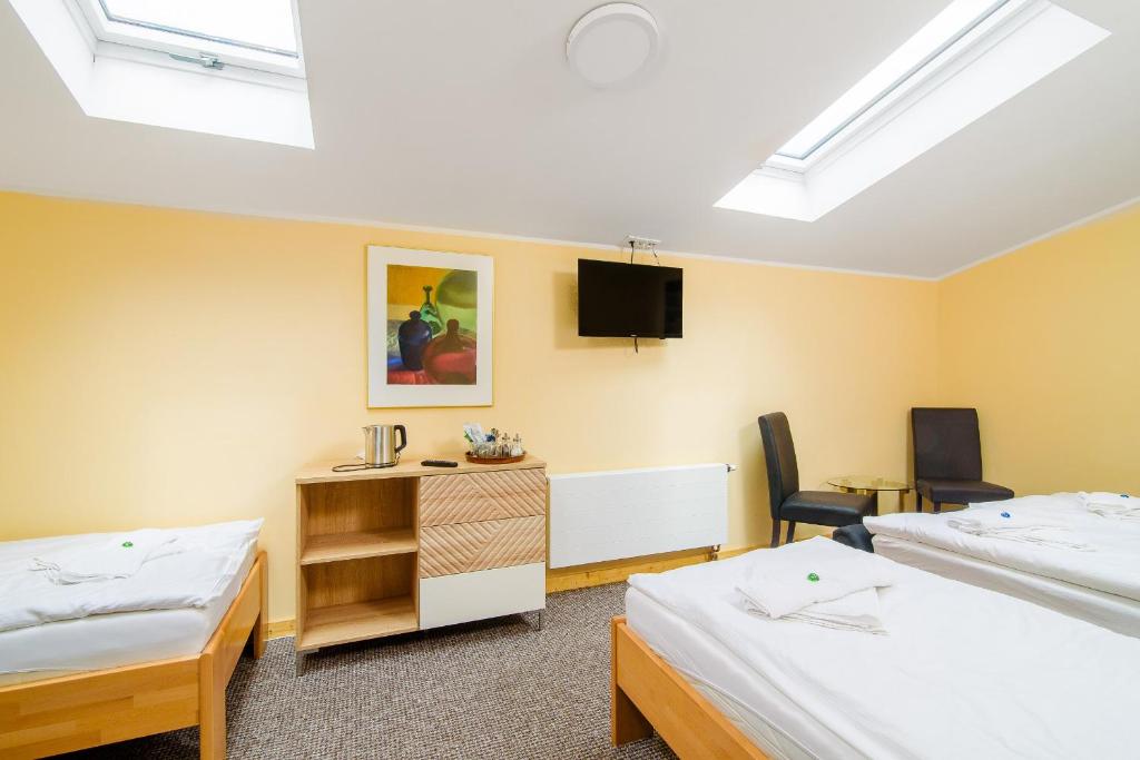 Postel nebo postele na pokoji v ubytování Hotel Max