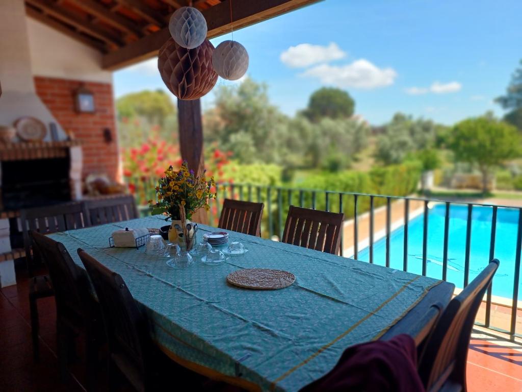 a table with a blue table cloth on a balcony at Casa da Torre in Sao Pedro de Tomar