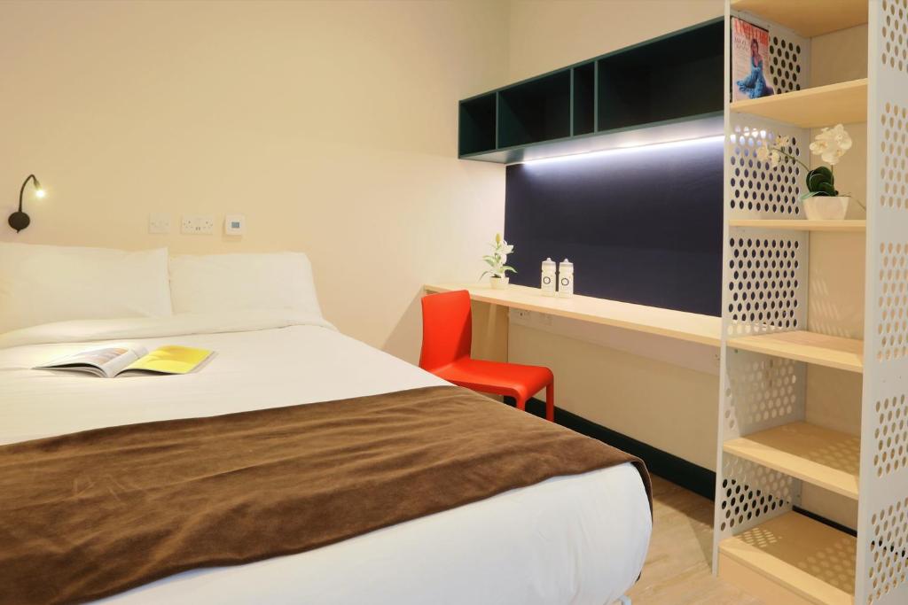 a bedroom with a bed and a desk and a chair at ALTIDO Affordable Dublin Parkgate - Adults only in Dublin