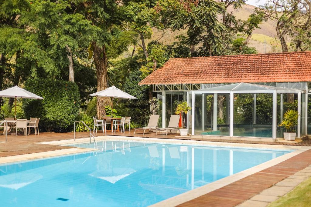 ein Pool neben einem Haus mit Pavillon in der Unterkunft Spa Posse do Corpo in Petrópolis