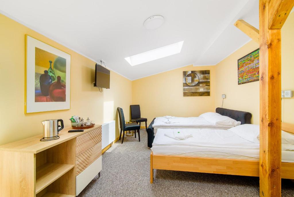 Postel nebo postele na pokoji v ubytování Hotel Max