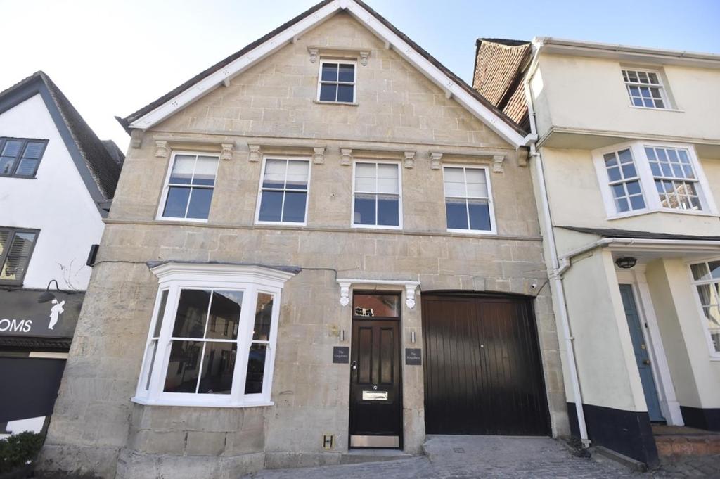 a brick house with a garage in front of it at the kingsbury 7even 8ight in Marlborough