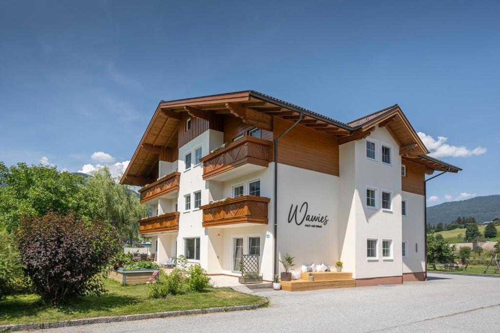 a building with a sign on the side of it at Wawies Apartments in Flachau