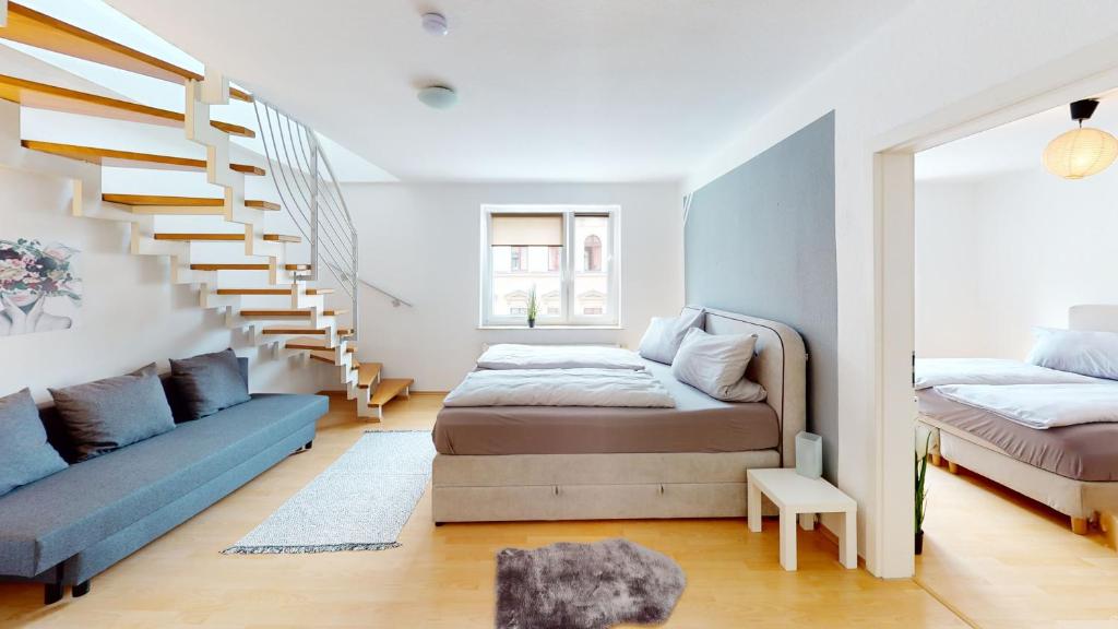 a bedroom with a bed and a stair case at Helle Ferienwohnung in 1a Lage in Leipzig