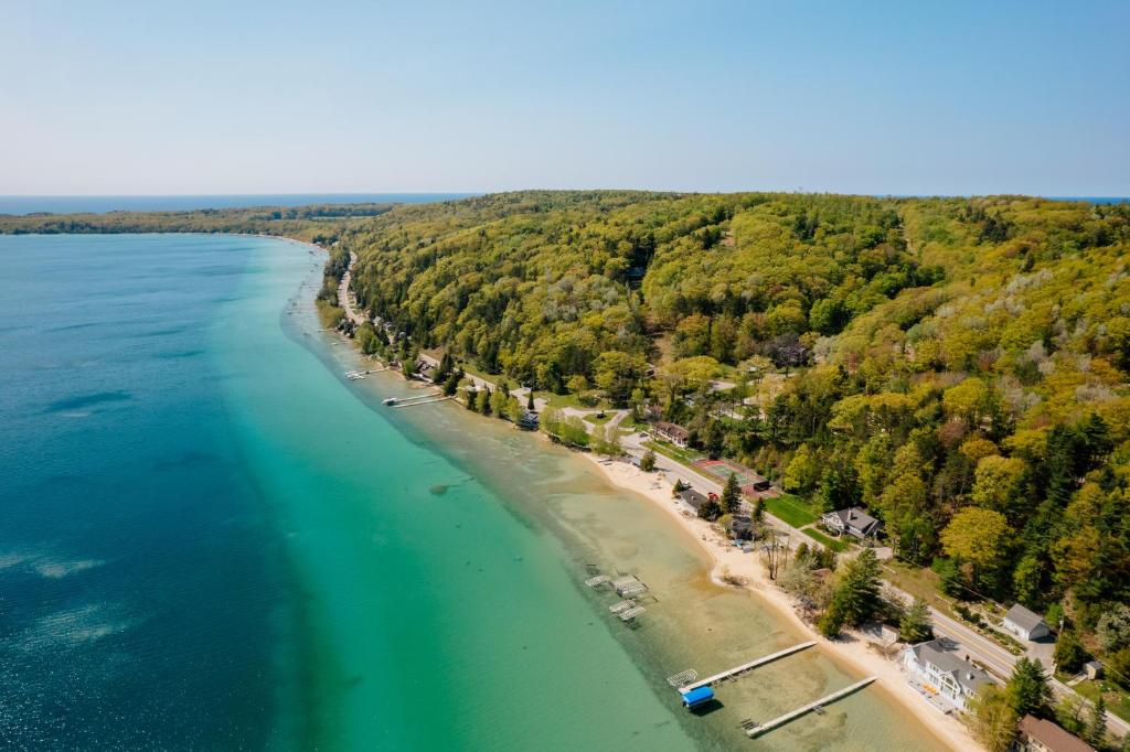 an aerial view of a beach next to the water at Chimney Corners Resort in Frankfort