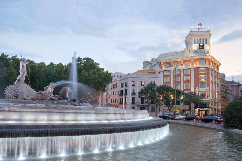 a water fountain in the middle of a city at NH Collection Madrid Paseo del Prado in Madrid