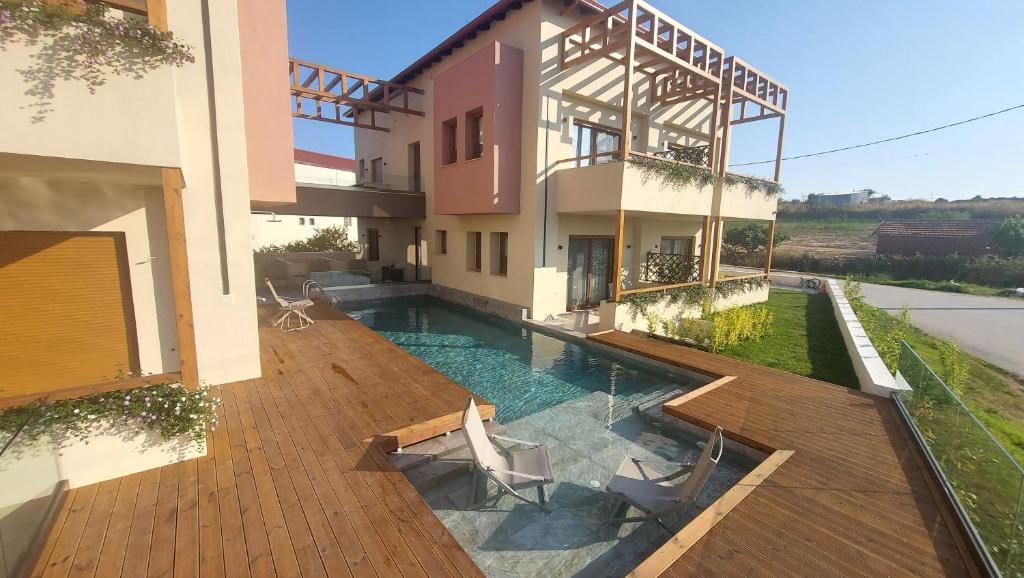 an external view of a house with a swimming pool at Kynara Elegant Living in Ierissos