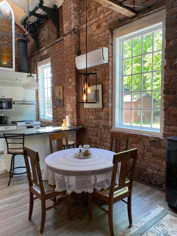 a kitchen and dining room with a table and chairs at Olde Foundry Apt in Pictou