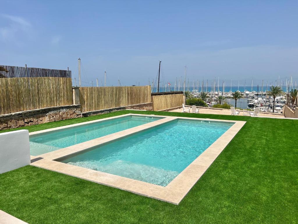a swimming pool on top of a green grass field at Son Veri D'Abaix in El Arenal