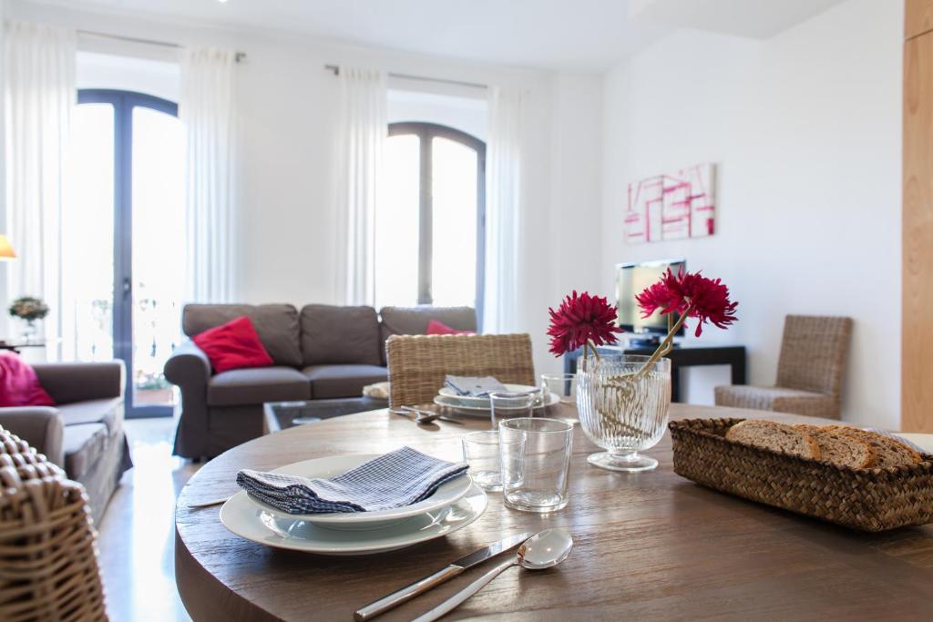 a living room with a wooden table and a couch at Sevilla Luxury Rentals - Alcazar in Seville