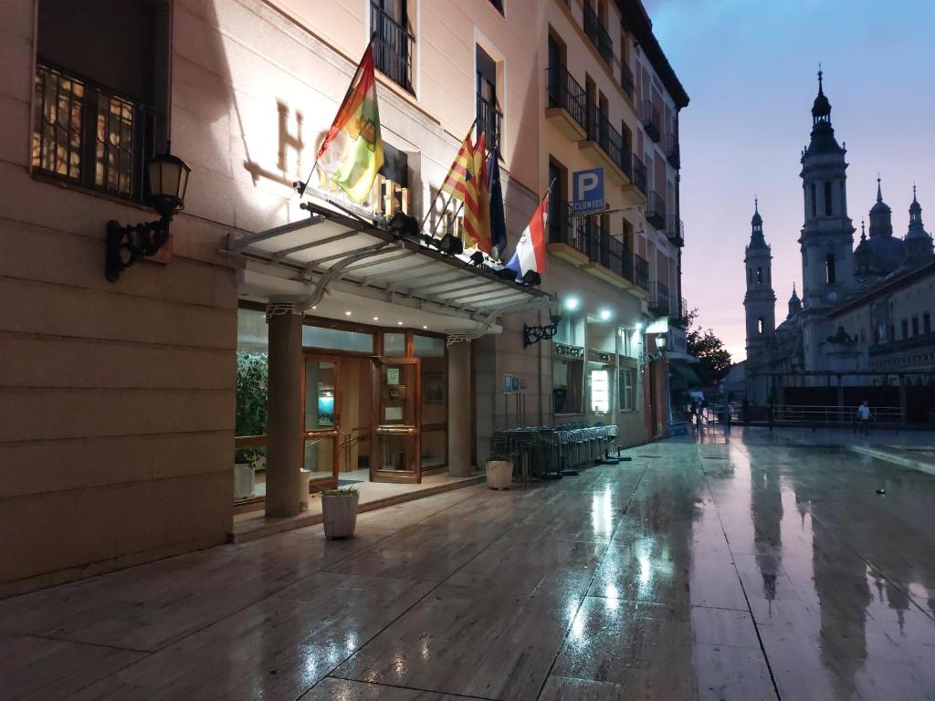 an empty street in a city at night at Hotel Tibur in Zaragoza