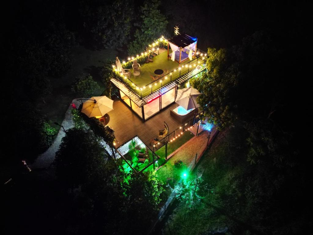 an overhead view of a house lit up at night at Oasis Glamping Tena Cundinamarca Cerca a Bogotá in Tena
