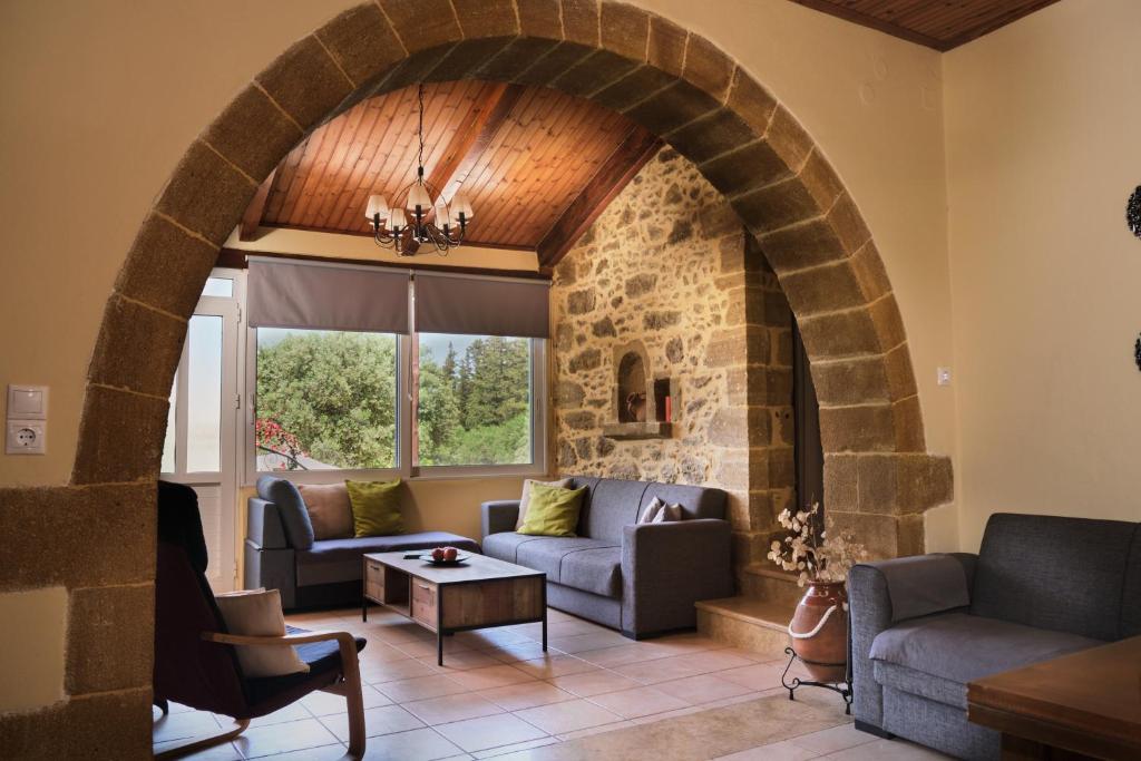 an archway in a living room with couches and a table at Batilas Garden House in Kissamos