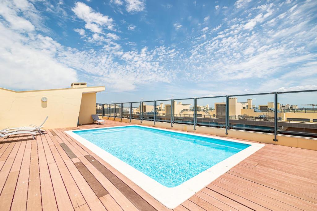 a swimming pool on the roof of a building at BeGuest Olhão Ria Formosa View in Olhão