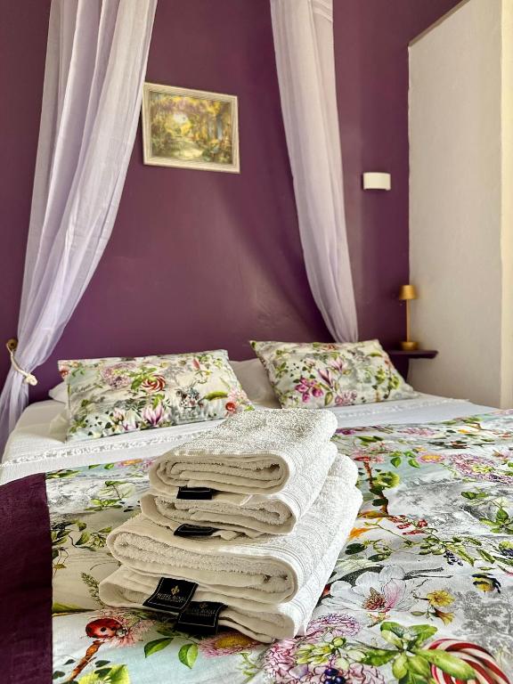 a bedroom with two beds with towels on them at Mas de la Sacristière in Jonquerettes